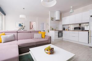 a living room with a couch and a table at Apartamenty Izerskie - ul. Cicha 13D-E in Świeradów-Zdrój