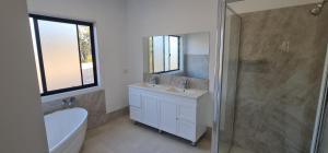 a bathroom with a sink and a shower and a toilet at Redhill Batemans Bay in Batemans Bay +9 photos