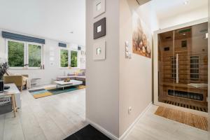 a living room with white walls and a large glass door at Apartamenty Izerskie - ul. Cicha 13D-E in Świeradów-Zdrój