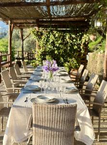 a long table with plates and wine glasses on it at Casa Paloma Private Villa in Cicerale