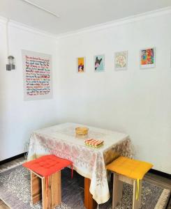 a table with colorful chairs in a room at The Bay Area in Cholpon-Ata