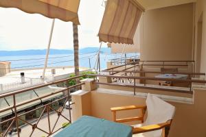 a balcony with a view of the ocean at G. Kiapekou in Loutra Edipsou