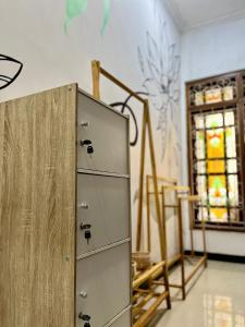 a metal cabinet in a room with a stained glass window at Bromo Breeze Malang in Malang