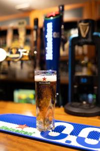 a glass of beer sitting on top of a table at The Lugger Inn in Weymouth
