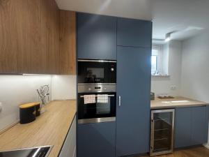 a kitchen with a stove and a blue refrigerator at Book your own amazing views on Alps in Bohinj