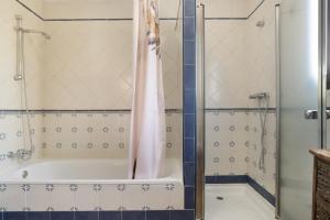 a bathroom with a tub and a shower at La Pedrosa in La Cimada +25 photos