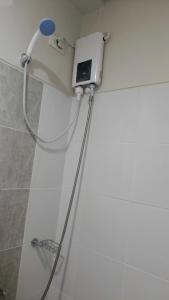a shower in a bathroom with a shower head at Onelakeshore back smx lanang in Davao City
