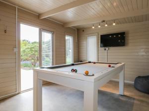 a pool table in a room with a tv at Sea Estate House in Littlehampton