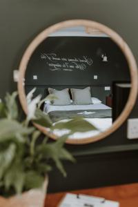 a bedroom with a bed in a mirror at The Lugger Inn in Weymouth +17 photos