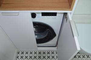 a washer and dryer inside of a kitchen cabinet at Spokojnia in Lubrza