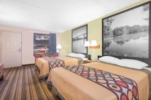 a hotel room with two beds and a large window at Super 8 by Wyndham Eufaula in Eufaula