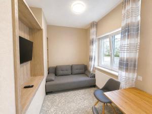 a living room with a couch and a table at Rabie Aparthotel in Prague