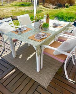 a table and chairs on a wooden deck at Scandinavian Villa near Sea with Sauna 4BR in Söderhamn