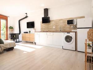 a kitchen with a washer and dryer in a room at Apartament Gritella ( Cim Apartaments ) in Cornudella +1 photo