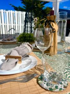 a wooden table with a plate and a wine glass at Scandinavian Villa near Sea with Sauna 4BR in Söderhamn