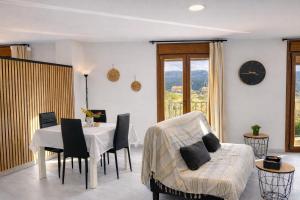 a living room with a table and a chair at Apartament Gritella ( Cim Apartaments ) in Cornudella