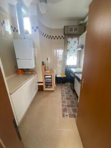 a kitchen with white cabinets and a tile floor at La Villetta in Giulianova