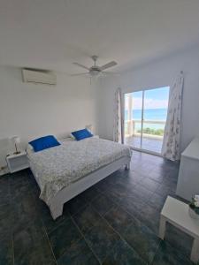 a bedroom with a bed and a large window at Hotel La Loma in Miches