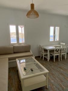 a living room with a couch and a table at Sto Faro - Blue in Kithnos