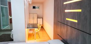 a room with a wooden door with a chair in it at Alpino Motel by Drops in Jundiaí
