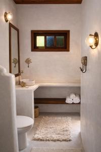 a bathroom with a sink and a toilet and a window at Pousada Lua Cheia Praia do Espelho in Praia do Espelho +39 photos