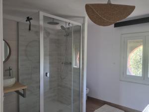 a bathroom with a shower with a glass door at Sous les étoiles 1 in Cusset