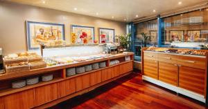 a bakery with a counter with a lot of food at Hotel MS Maestranza Málaga Centro in Málaga