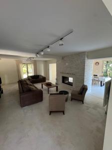 a large living room with couches and a fireplace at Villa Bon Cavai in Mornas