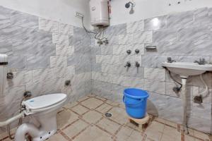 a bathroom with a toilet and a sink at Hotel Moonlight Manali in Manāli