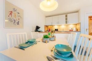 a kitchen with a table with two bowls on it at Harzhygge Braunlage in Braunlage +14 photos