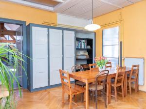 a dining room with a wooden table and chairs at La Colonie, former watch factory in Les Pommerats +10 photos