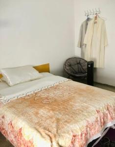 a bedroom with a bed and a clothes rack at Cyrnos in Fez