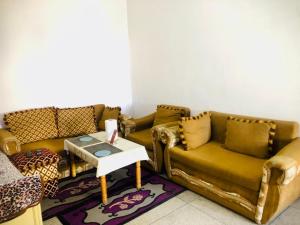 a living room with two couches and a table at Cyrnos in Fez