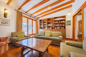 a living room with couches and a table at Villa Mas Blanc - PlusHolidays in Benissa
