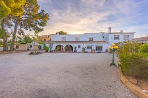 a large white house with a large driveway at Villa Mas Blanc - PlusHolidays in Benissa