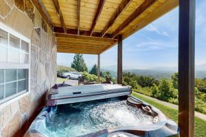 a hot tub on the side of a house at Hot Tub & Stunning Views! Hayesville Retreat in Cedar Cliff