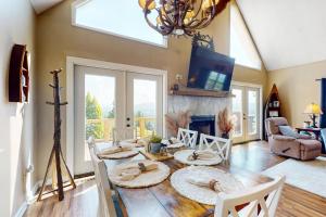 a living room with a table and chairs and a tv at Hot Tub & Stunning Views! Hayesville Retreat in Cedar Cliff