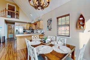 a kitchen and dining room with a table and chairs at Hot Tub & Stunning Views! Hayesville Retreat in Cedar Cliff