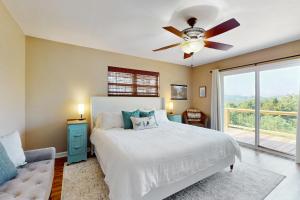 a bedroom with a bed and a ceiling fan at Hot Tub & Stunning Views! Hayesville Retreat in Cedar Cliff +34 photos