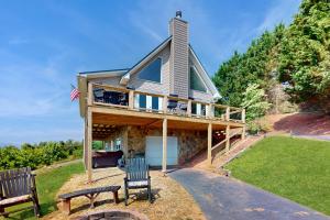 a house with a wrap around deck with two benches at Hot Tub & Stunning Views! Hayesville Retreat in Cedar Cliff