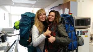 two women posing for a picture next to a pile of backpacks at Loft 109 Backpackers Hostel in Tauranga