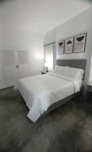 a white bedroom with a large white bed at Purevibe Horizon House Ocean View Villa Port Antonio in Port Antonio