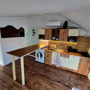a kitchen with a wooden table in a room at Wood Nest in Bragadiru