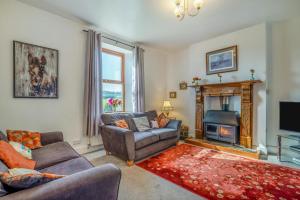 a living room with two couches and a fireplace at 6 Bed in Blackburn oc-c38221 in Balderstone