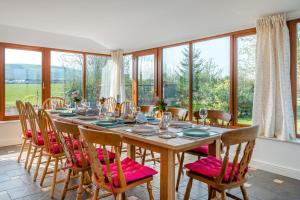 a dining room with a table and chairs and windows at 6 Bed in Blackburn oc-c38221 in Balderstone