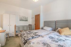 a bedroom with a bed and a crib at 6 Bed in Blackburn oc-c38221 in Balderstone