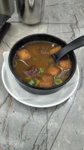 a bowl of soup on a plate on a table at Leisure Paradise in Kharar