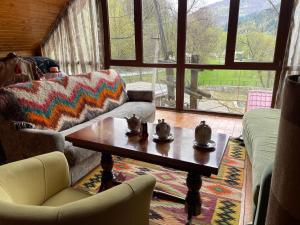 a living room with a coffee table and a couch at Guest house Nad Tisou in Kvasy