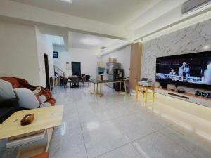 a living room with a large flat screen tv on a wall at Up villa in Taibao