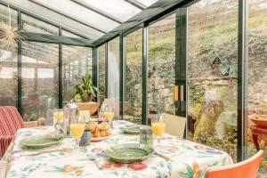 a table in a conservatory with a table cloth on it at 2 Bed in Buxton oc-dcbap in Longnor